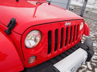 2015 Jeep Wrangler Unlimited Sahara front closeup red